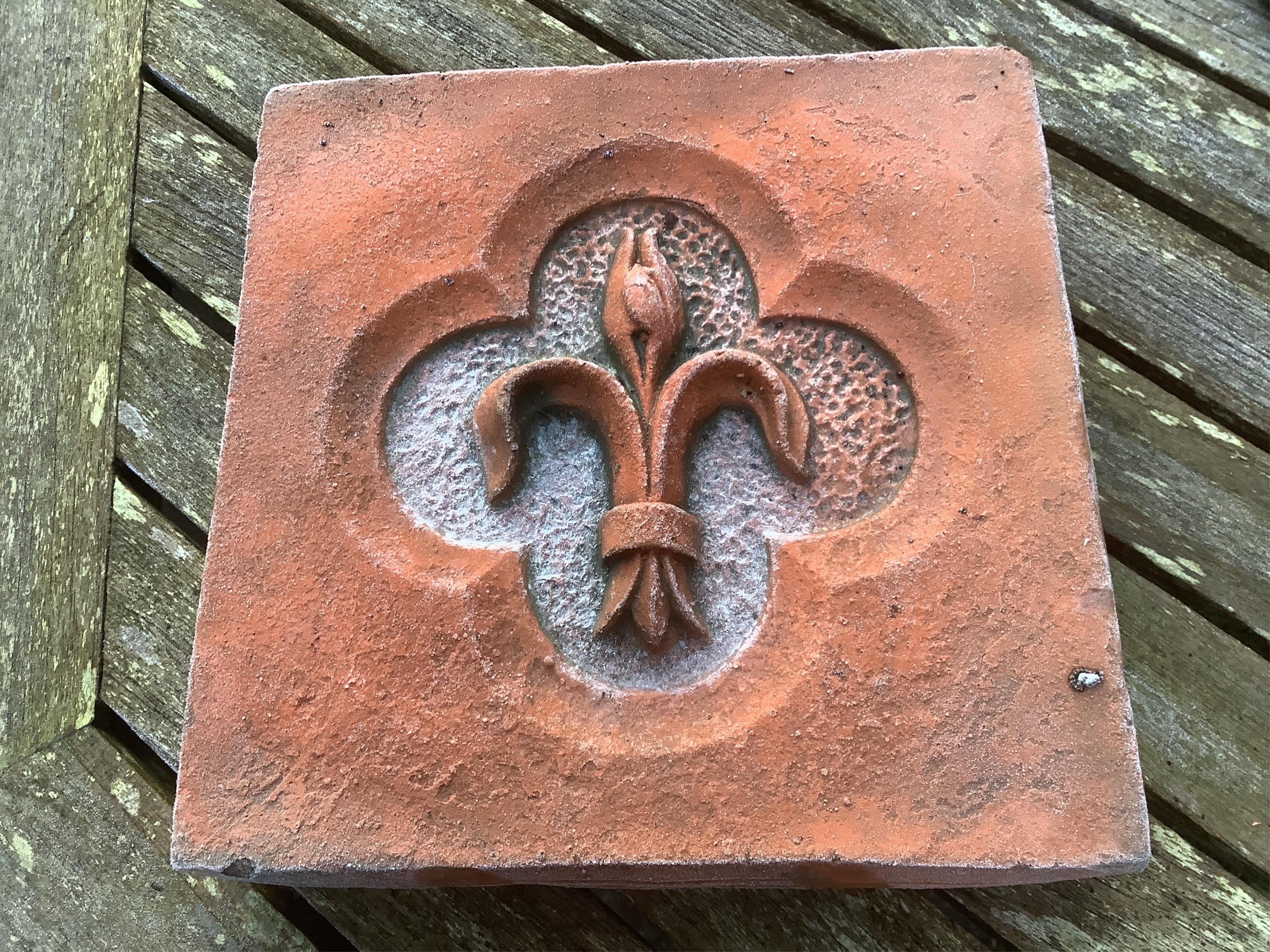 Six terracotta decorative tiles, largest width 21cm. Condition - fair